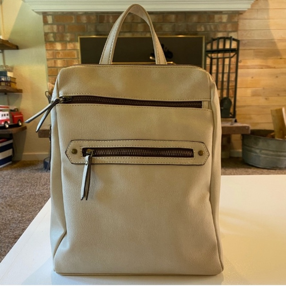 Backpack  color Bone New 4 zip pockets & 2 sleeve pockets Excellent condition